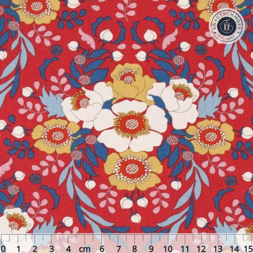 Tilda-Stoff Anemone in Red mit symmetrischem Blütenmuster in Weiß, Gelb und Blau auf rotem Fond, mit Zentimeter-Maßstab.