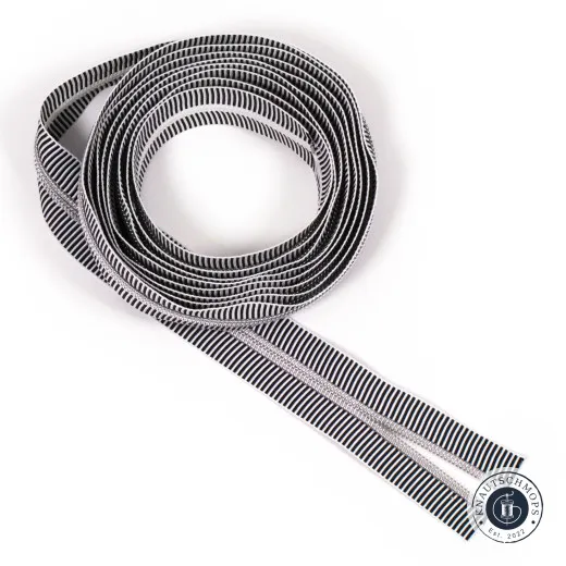 Aufgerolltes Endlos-Reißverschlussband von Sassafras Lane Designs in Black Stripe mit schwarz-weiß gestreiftem Band und Zähnen in Nickel-Finish.