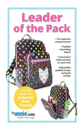 Schnittmuster-Cover „Leader of the Pack" mit Foto des bunt gepunkteten Rucksacks mit Wolfsmotiv-Vortasche, geschlossen und gepackt mit Schulsachen