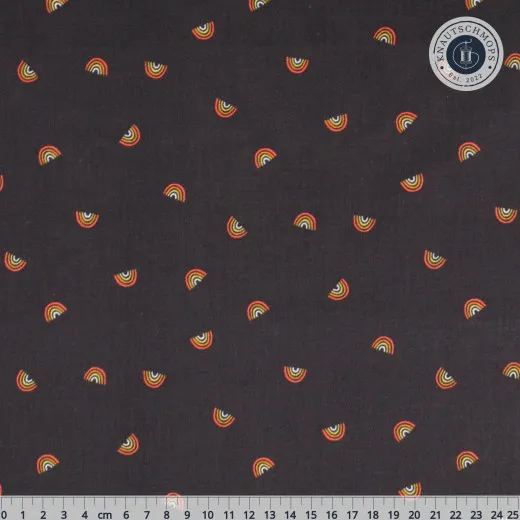 Nahaufnahme des Musters mit kleinen Mini-Regenbögen in warmen Orange- und Gelbtönen auf tiefschwarzem Grund, mit Zentimeter-Lineal.