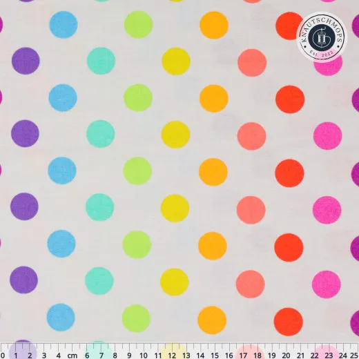 Bunte Punkte des Musters „Disco Poms" auf hellem Whisper-Grund, Lineal zum Größenvergleich.