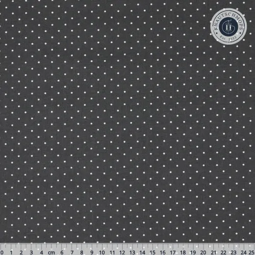 Kleine weiße Punkte des Musters „Tiny Dots" auf dunklem Carbon-Grund, Lineal zum Größenvergleich.