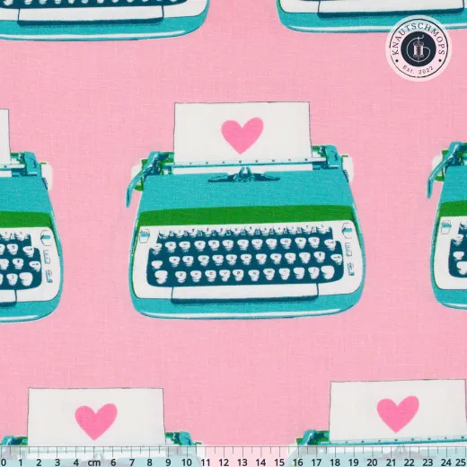 Ruby Star Society Canvas Best Day Ever Typewriters Posy Rosafarbener Canvas-Stoff mit türkisfarbenen Retro-Schreibmaschinen und pinken Herzen, mit Zentimeter-Maßstab am unteren Bildrand.