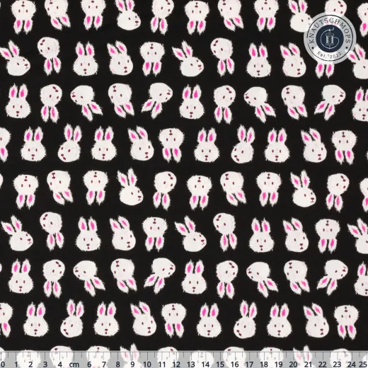 Ruby Star Society Hello Alice Rushing Rabbit Black Schwarzer Baumwollstoff mit cremefarbenen Hasenkopf-Silhouetten und rosa Ohren, mit Zentimeter-Maßstab am unteren Bildrand.