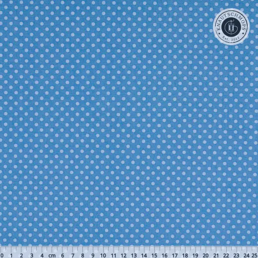 Hellblauer Baumwollstoff mit weißen Punkten, mit Zentimeter-Lineal zur Maßstabsdarstellung