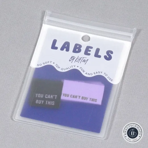 Verpackung der Kylie and The Machine Weblabels 'You Can't Buy This' in glitzernder Metallic-Version, Lila und Schwarz.