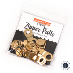 Verpackung der Sassafras-Lane-Zipper-Pulls in Gold mit Aufschrift 6 Gold Zipper Pulls auf schwarzem Hintergrund.