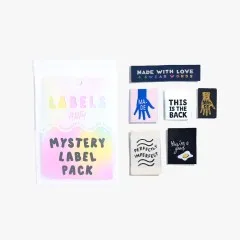 Mögliche Labels aus dem Mystery-Paket: „Made With Love & Swear Words", „Made"-Hand-Motive in Blau und Gold, „This Is The Back", „Perfectly Imperfect" und „You're a good egg".