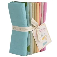 Das Fat-Quarter-Bundle von vorne mit sichtbarem Farbverlauf von Pink über Koralle bis Türkis.