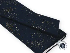 Gefaltete Canvas-Stoffbahn mit goldenen Metallic-Farbspritzern in Navy-Blau.