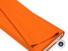 Gefaltete Stoffbahn in Ginger-Orange mit sichtbarer Webkante und Tilda-Etikett.