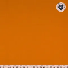Nahaufnahme des orangen Baumwollstoffs Gingerbread mit Lineal bis 40 cm