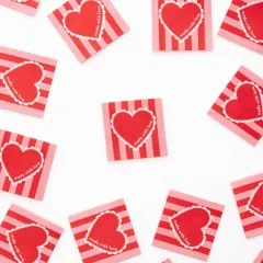 Mehrere „Made with Love“-Labels locker verstreut, teils diagonal liegend.