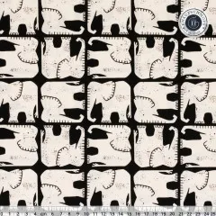 Nahaufnahme des grafischen Elefanten-Rastermusters in Creme auf schwarzem Grund, mit Zentimeter-Lineal.