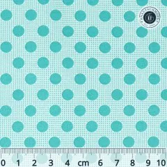 Nahaufnahme des Tilda-Musters „Basic Dots" in Dark Teal mit dunkeltürkisen, ca. 7mm großen Punkten auf mintgrünem Fond, mit Maßband zum Größenvergleich.