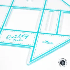 Nahaufnahme des Binding Holders mit Detailansicht der Aussparungen und des Quilty-Tools-Schriftzugs.