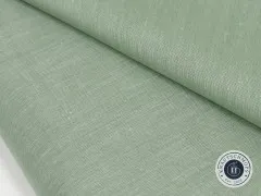 Detailaufnahme einer gefalteten Stoffecke des Sage-farbenen Chambray-Gewebes.