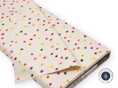 Stoffballen mit Ruby Star Society Banderole, cremefarbener Baumwollstoff mit bunten Sternen