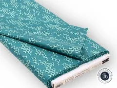Gefalteter Stoffballen mit Etikett „Bloomsville 100513 Cottonbloom Petrol".