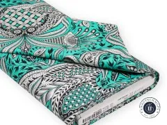 Gefalteter Stoffballen des Designs „Gift Rapt“ in Mint mit sichtbarem Herstelleretikett.
