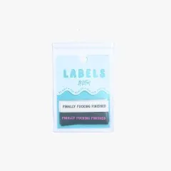 Verpackungskarte der „Finally Fucking Finished"-Labels freigestellt auf hellem Hintergrund.