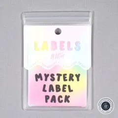 Holografisch schimmernde Verpackungskarte „Mystery Label Pack" von KATM, gerade von vorne fotografiert.