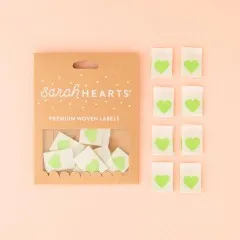 Sarah Hearts Verpackungskarton mit 8 cremefarbenen Weblabels mit grünem Herz-Motiv.