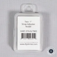 Verpackte ByAnnie's-Gurtversteller in durchsichtiger Box mit Etikett „Two-1 Zoll Strap Adjuster Nickel" und Artikelnummer HAR1-STA-N-TWO