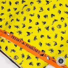 Webkante mit Aufdruck Freaky Familiars auf orangem Grund neben gelbem Spinnenstoff