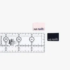 Labels 'me made' in Rosa und Schwarz mit Lineal zum Größenvergleich.